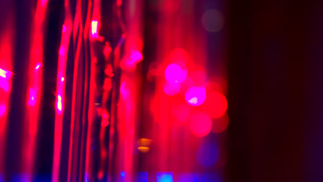 Defocused-Close-Up-Shot-Of-Sparkling-Tinsel-Curtain-In-Night-Club-Or-Disco-With-Flashing-Strobe-Lighting-2